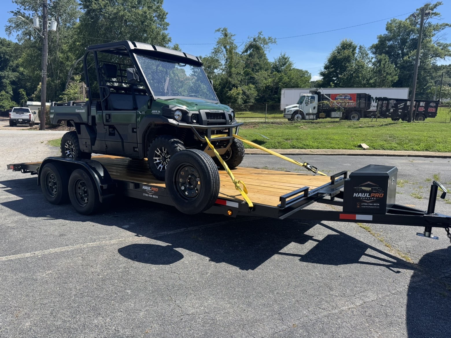 Haul Pro Hauling trailer hauling a Kawasaki Mule 4x4 UTV strapped down for transport